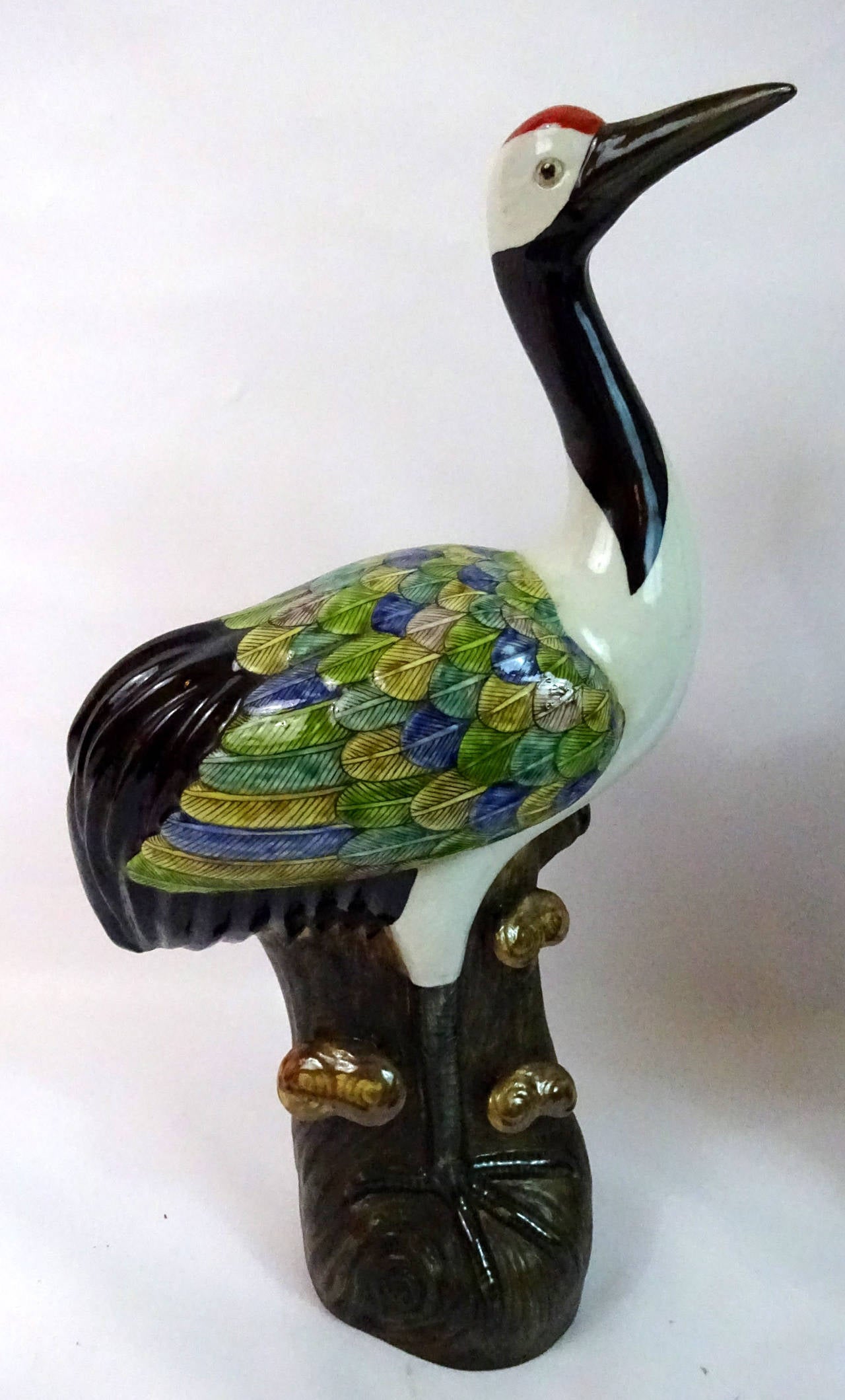 Left and right pair of Early 20th Century Chinese polychrome porcelain storks on wooden perches, with four character marks on the bottom.