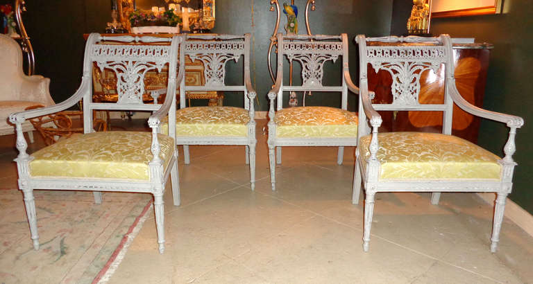 A set of 4 Louis XVI painted armchairs with a lightly distressed finish.