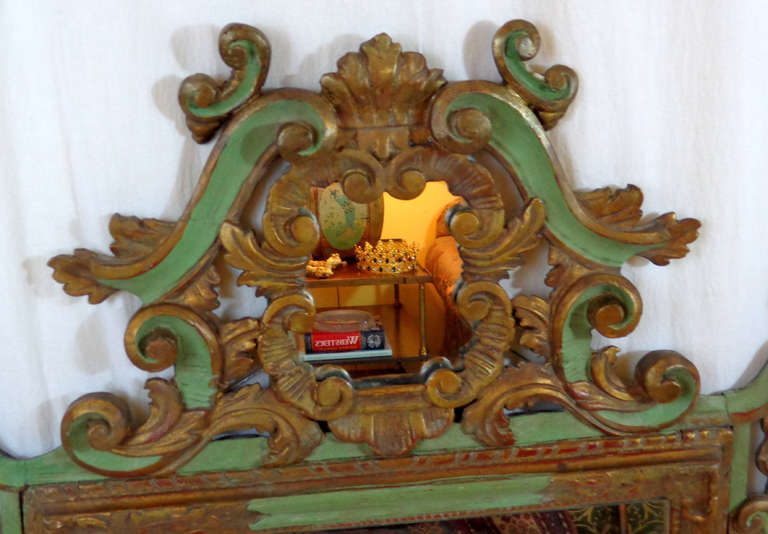Ornately carved Rococo style painted and gilt wood mirror