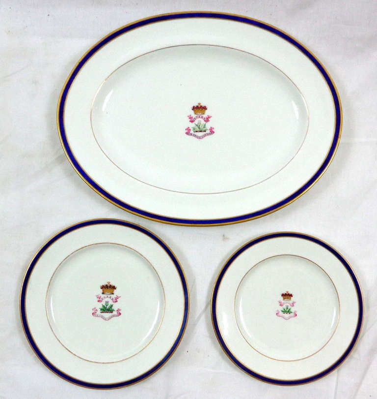 A 9-piece set of dinner ware with a blue and gold rim, and a centre displaying the crest and motto of the Perceval Family beneath an Earl's Coronet. The large platter and some of the plates are by Wedgwood, others are by Copeland.

Measure: Four