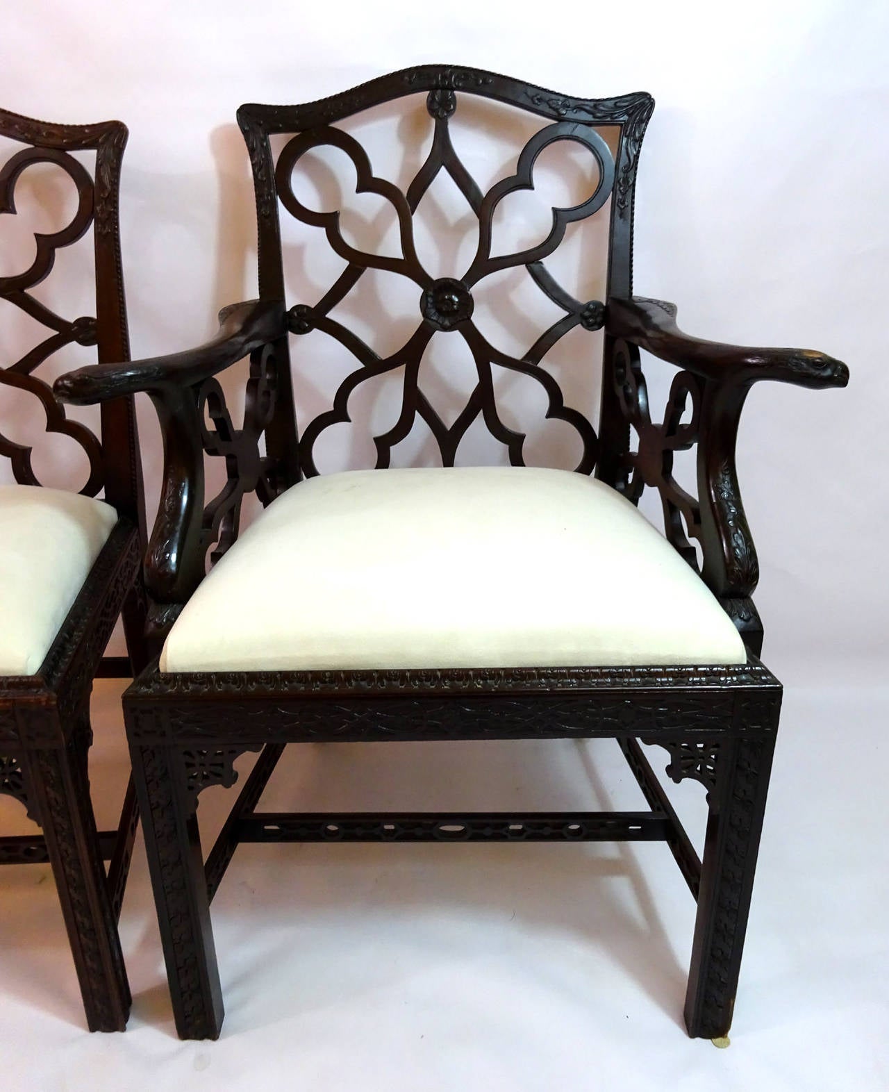 Set of eight dining chairs consisting of two armchairs and six side chairs, crafted in the late 19th century in England. The frames are made of mahogany with an unusually designed back.