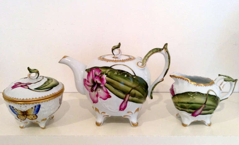 The three piece tea set is a one-of-a-kind Collector's Item.  Designed by Anna Weatherley, hand-painted in her studio in Budapest, Hungary.

The painting is very detailed.  The butterflies, the leaves, the flower petals are all painted with the