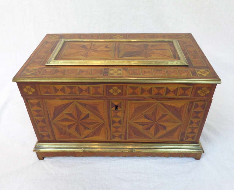 Inlaid box with star design of green tinted sycamore with brass trim, a removable insert tray, and a bottom compartment with sliding cover.