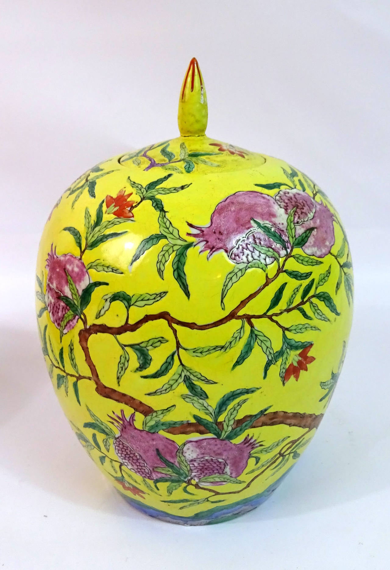 Pair of Chinese Famille Jaune pomegranate covered vases with six-character marks.