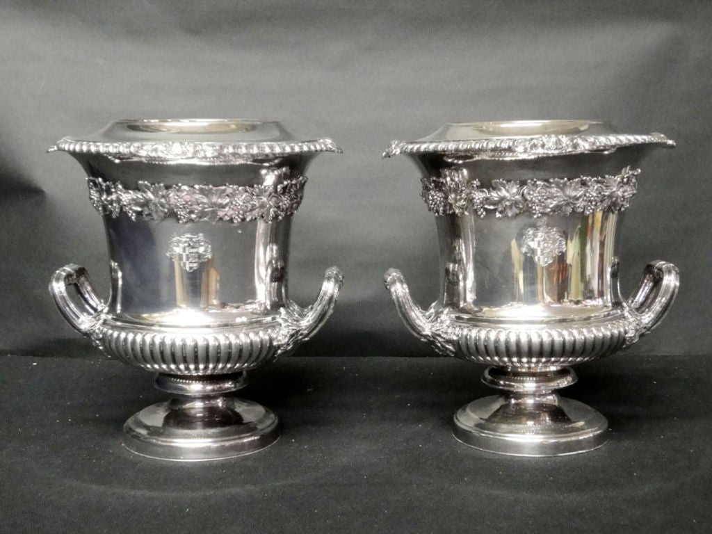A Pair of Matthew Boulton (1728-1809) Wine Coolers each with a family crest & encircled with an applied grape & vine frieze. Boulton dominated silver making in Birmingham during the last thirty years of the 18th century.  Wine inserts can be removed.