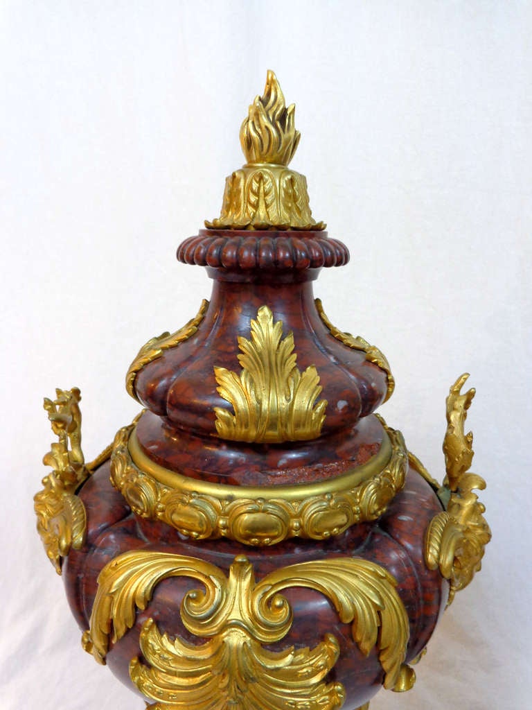 A Pair of Louis XVI Style Rouge Marble Urns with Bronze Doré Mounts.