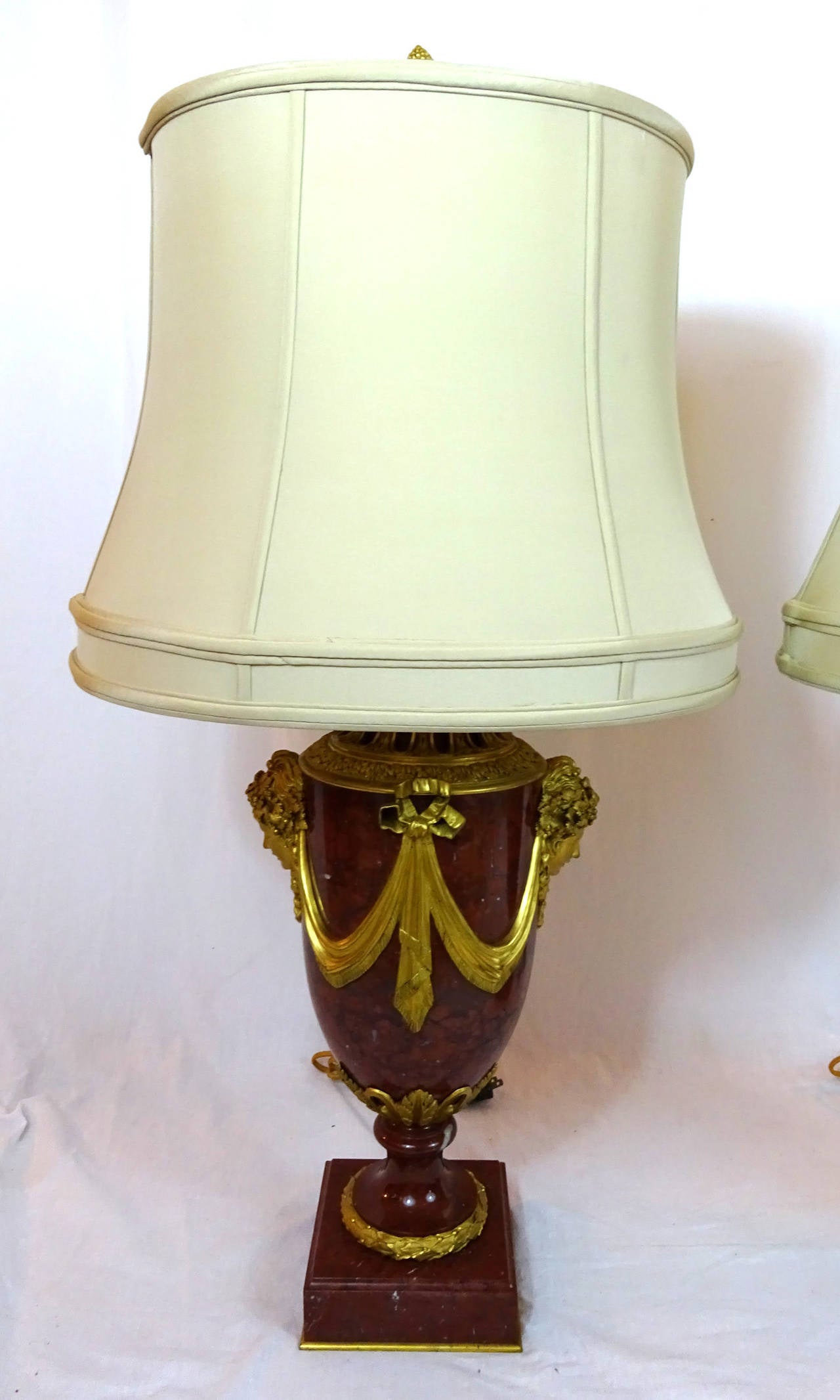 Pair of 19th century French red marble lamps with ormolu masks and mounts.