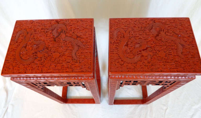A rarely encountered pair of carved cinnabar lacquer censer stands of rectangular form raised on four square legs joined at the base by stretchers.