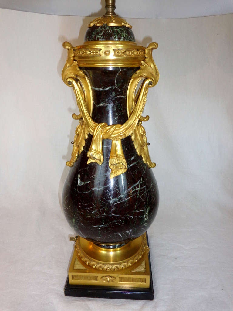 Pair of Louis XVI style marble lamps with draped swags of bronze doré.