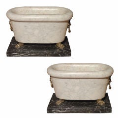 A Pair of White Marble Tubs on Black Marble Bases