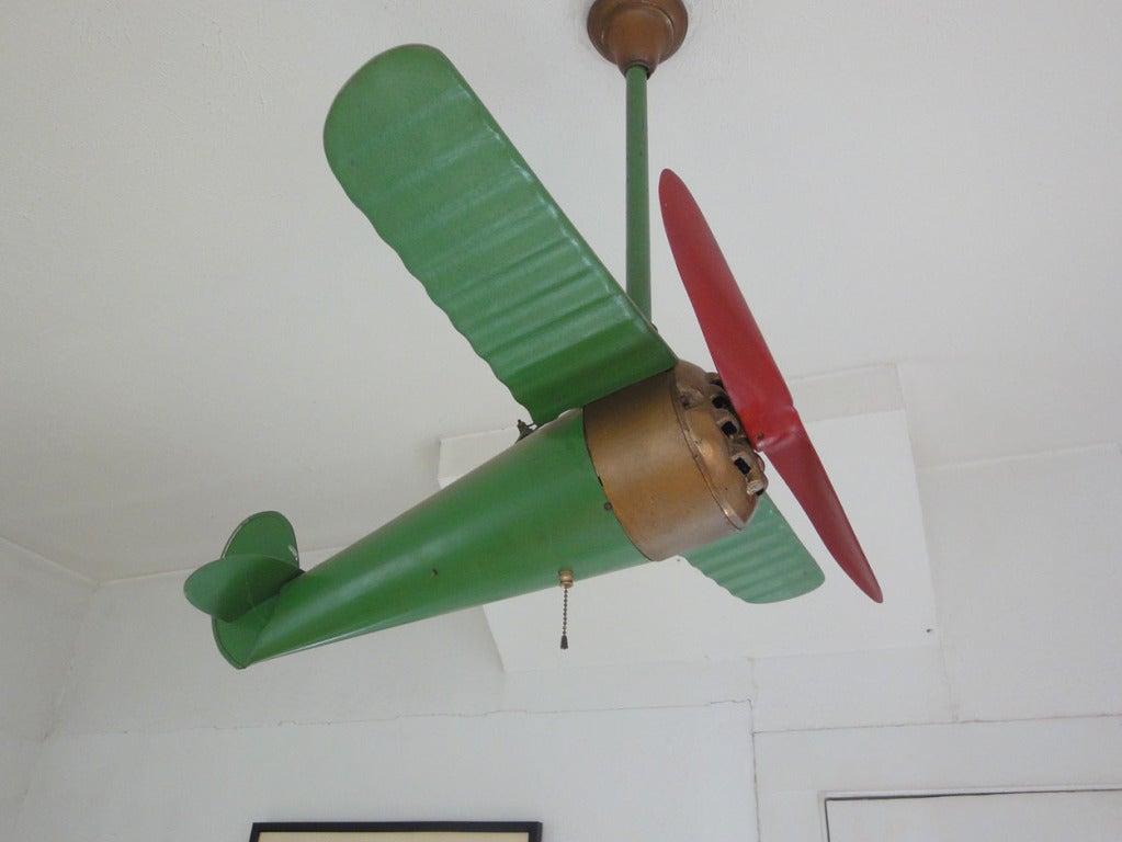 Rare Lindy Airplane Ceiling Fan manufactured for Kennedy Machine & Brass Co., Dallas, Texas, in honor of Charles Lindbergh's flight. The working fan moves air with the red propeller.
Original brass plate displays the name 