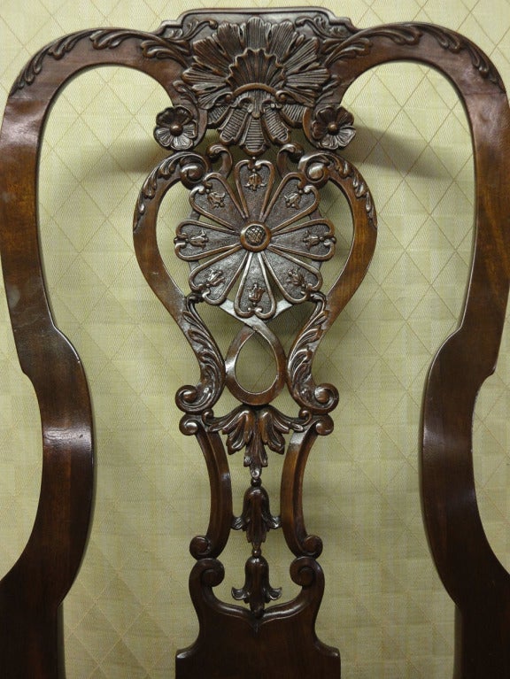 Queen Anne Walnut Side Chair with Needlepoint Seat.The carved & shaped crest rail features a leaf & shell carved medallion flanked by curving acanthus leaves. A pair of flower heads rest above the s-curved uprights of the splat that enclose a