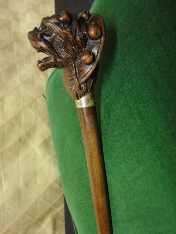 Mahogany Walking Cane with Carved Dog's Head Wearing a Collar of Bells. Note the attention to detail.