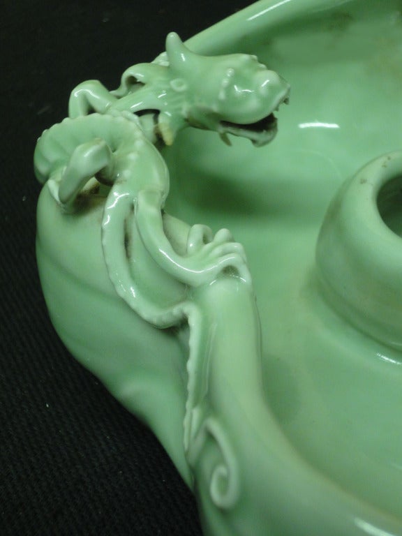 19th Century Chinese Celadon Brush Washer with an Organic shape, & classic Chinese symbols are depicted beside a swirling pool: the dragon, bat, and Lingzhi mushrooms.