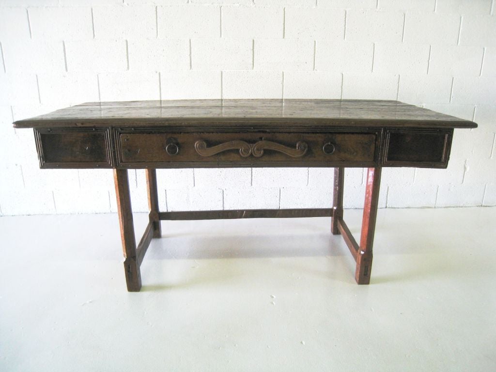 Carved rustic Spanish fruitwood table. Drawers at each end of the table and on one side. 32