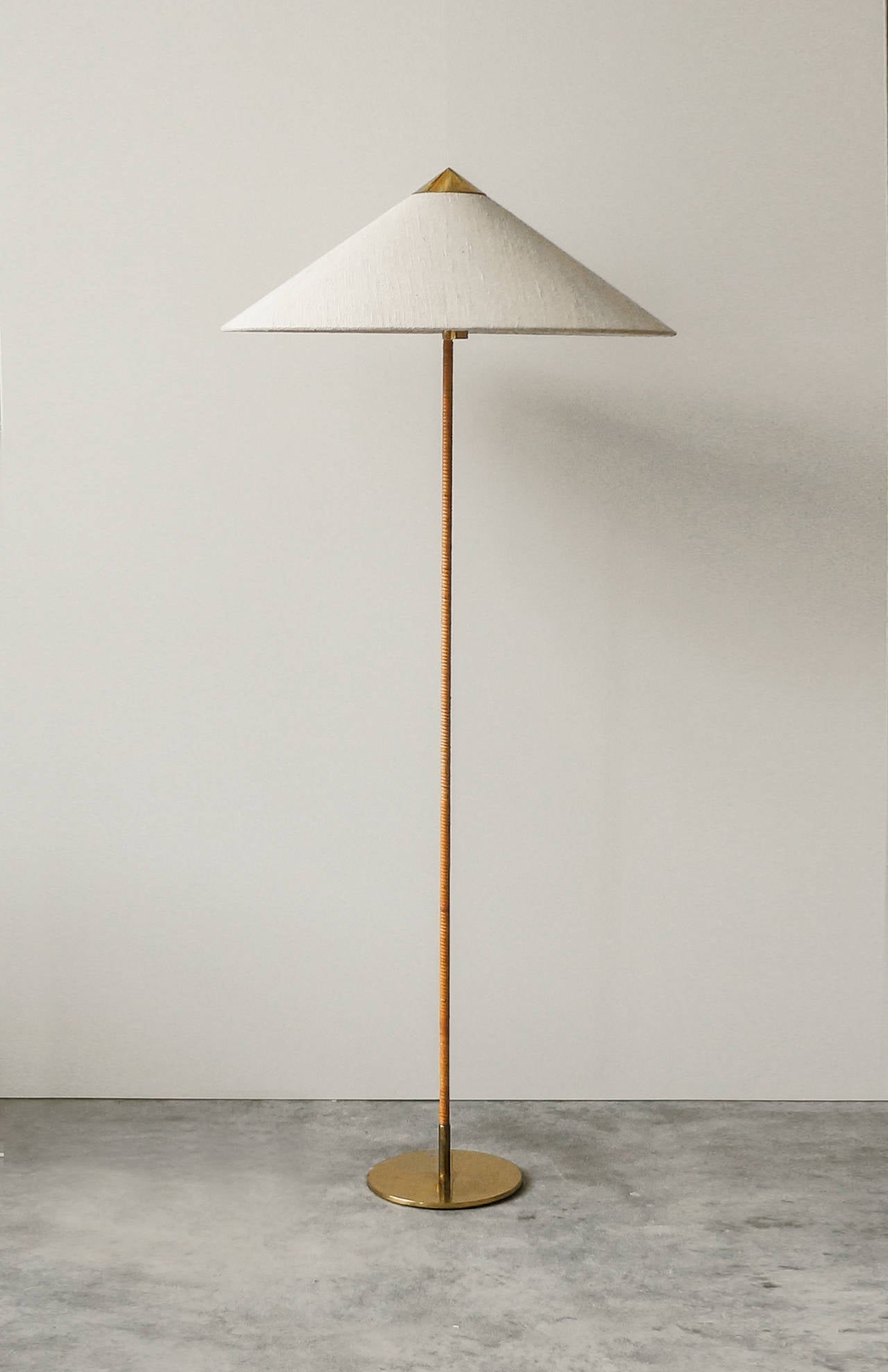 Paavo Tynell Floor lamp.

Taito Oy.
Finland, circa 1940s.
Solid brass, metal, rattan, wool shade.
Measures: 24 diameter x 60 H inches.

Model no. 9602, designed and manufactured, circa 1940s. Manufactured by Taito Oy, Finland.