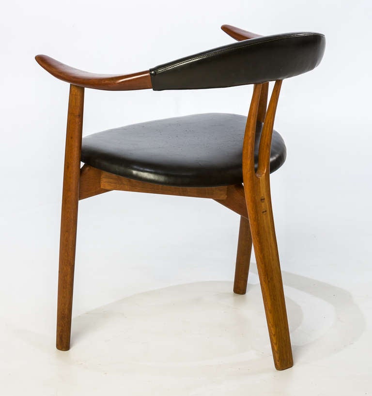 Arne Hovman-Olsen armchairs, set of four in original leather,

Denmark, 1956.
Mogens Kold.

Stained oak, teak, vinyl.
25.5 W x 21 D x 29.5 H inches.

Signed with manufacturer's mark to underside of each chair: [Craftmanship Mogens Kold Made