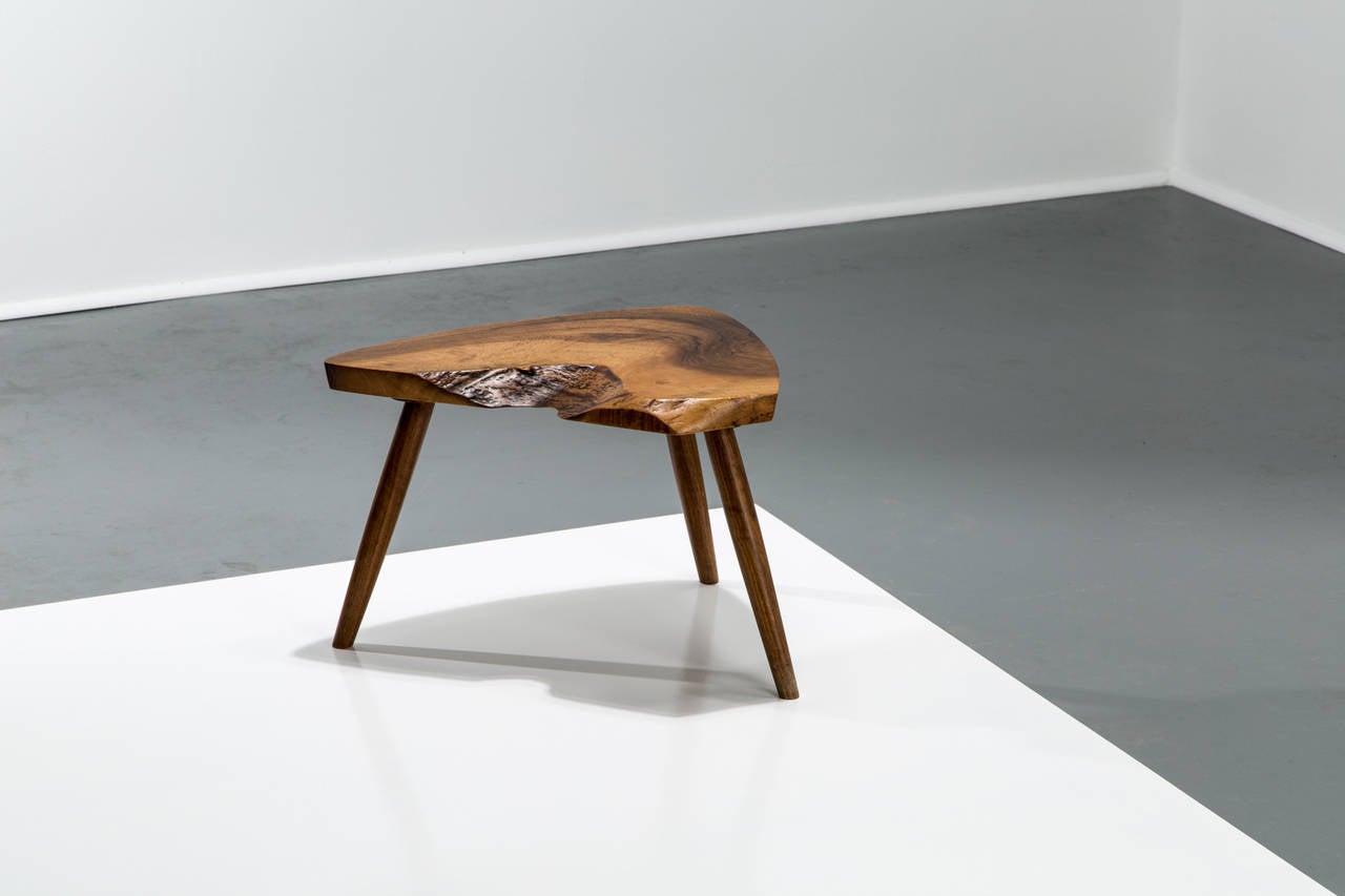 George Nakashima.

Footstool.

USA, circa 1973.
Walnut.
Measures: 19 W x 14 D x 12.5 H inches.

Underside signed 