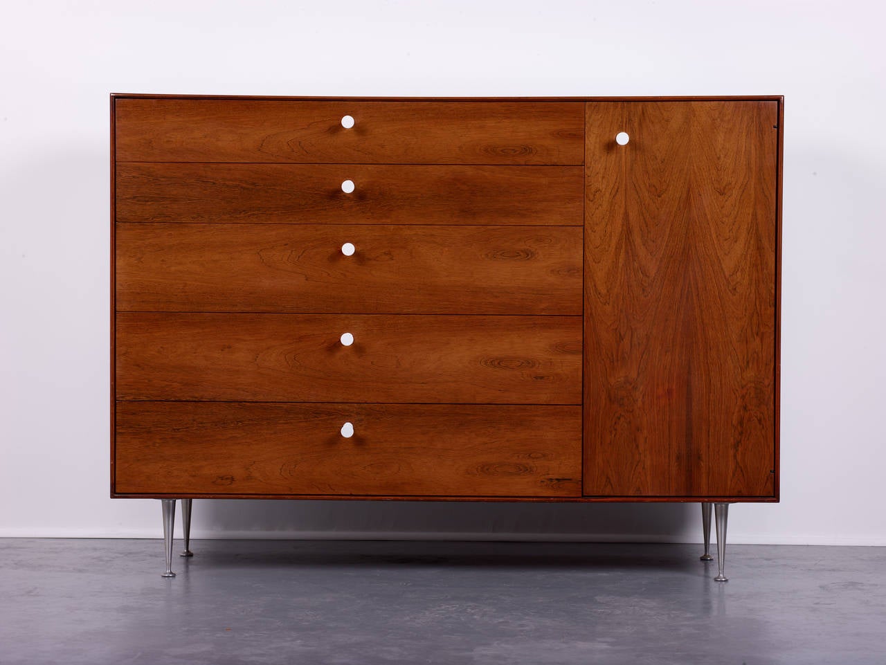 George Nelson & Associates.

Thin edge cabinet, model 5245.

Herman Miller,
USA, 1952.
Rosewood, aluminum, porcelain.
Measures: 55.5 W x 18.5 D x 40.5 H inches.