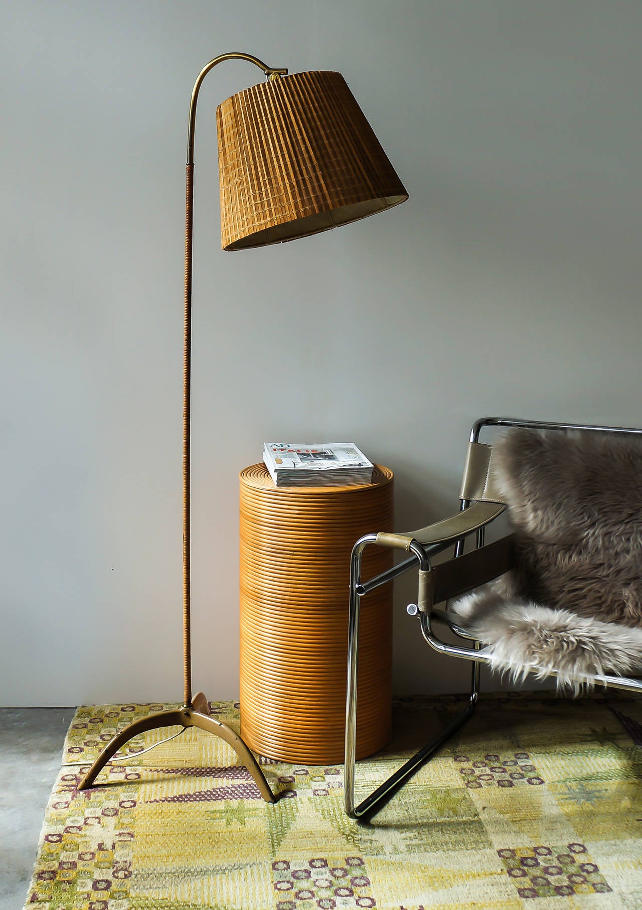 Paavo Tynell.

Floor lamp model 9609.

Taito Oy, Finland, late 1940s. 
Brass, cane, wood splint, painted cast iron base.
Measures: Height circa 152 cm, 39 width, depth 43 cm.

Impressed with manufacturer’s mark OY TAITO AB as well as the