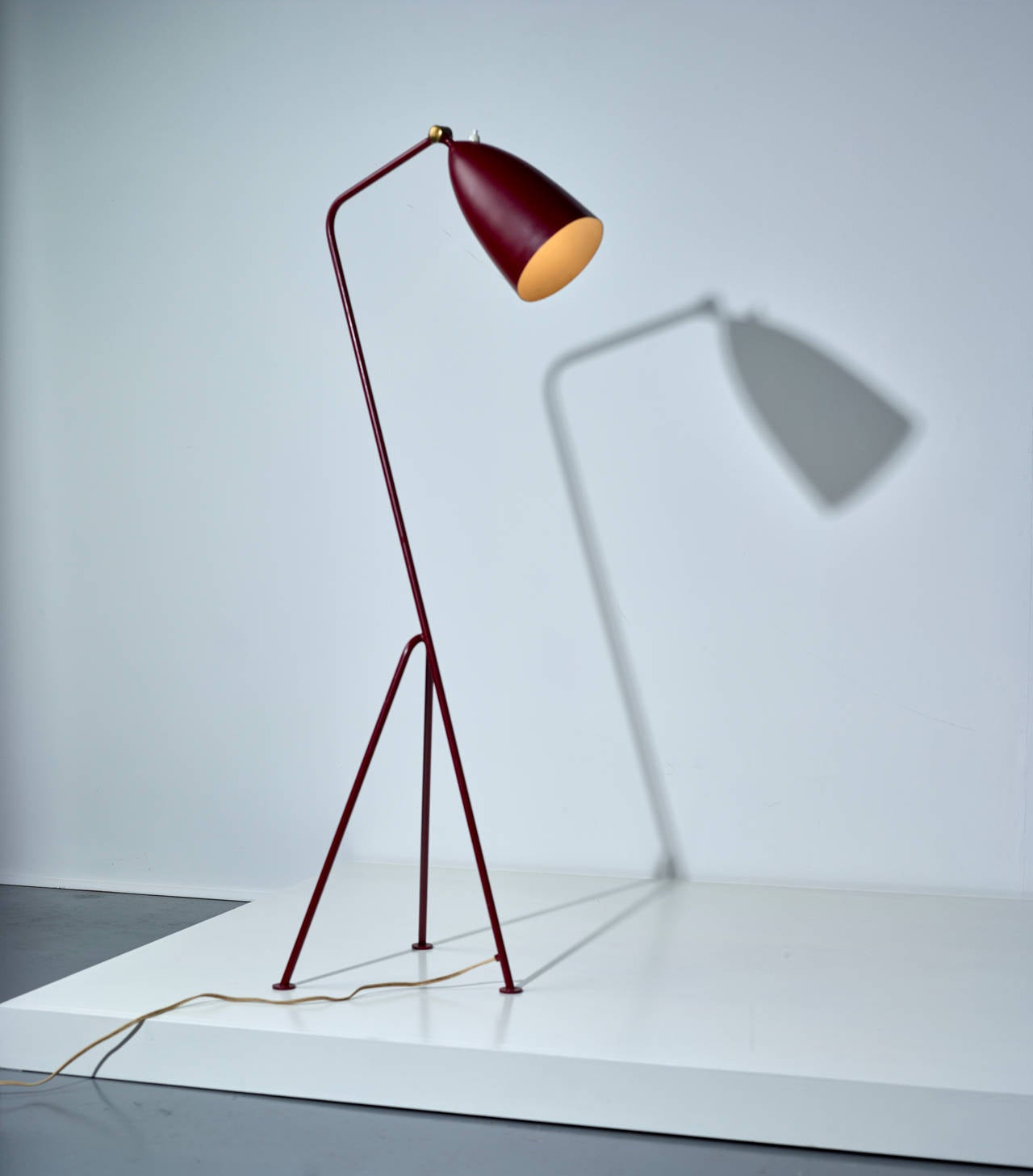 Early "Grasshopper" floor lamp, model 831 in red. Manufactured by Bergboms Malmö, Sweden. Interior impressed "G-33 BERGBOM MAX 25W."

Painted aluminum, painted tubular metal, brass,
circa 1950.
Measures: 149.5 x 37 x 37