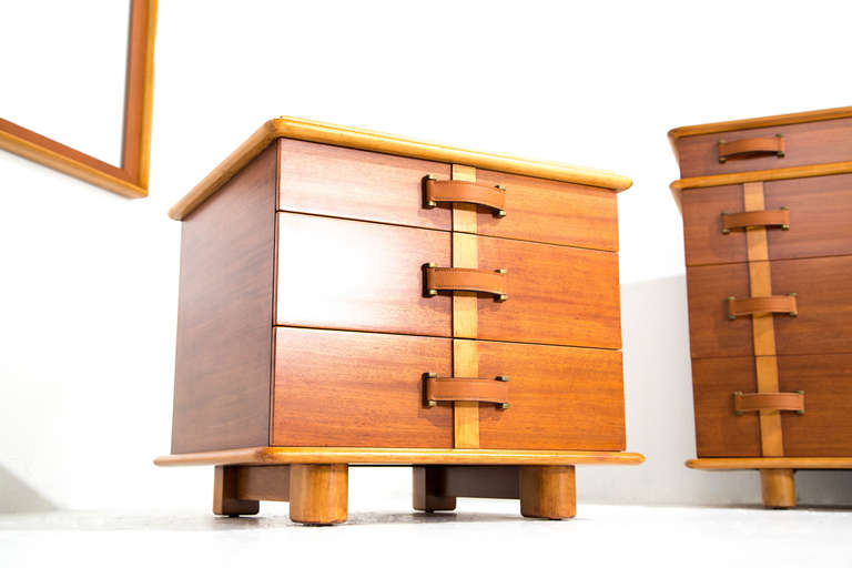 Paul Frankl eight-drawer dresser, three-drawer cabinet, leather-seat bench, mirror by Johnson Furniture Co. USA, 1940s. Mahogany, birch. Pieces are stencil marked and branded.
dresser: 66 w x 32 h x 22 d inches 
mirror:  50 w x 33.5 h x  2.25 d