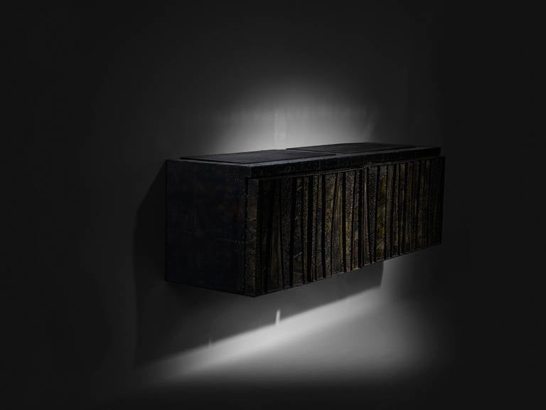 Signed Paul Evans sculptured metal cabinet, bronze bas relief design.

Paul Evans Studio for Directional
USA, 1967
welded and enameled steel, wood, slate
72 W x 22 D x 22.5 H inches 

Hand forged Paul Evans sculptured metal wall hung cabinet