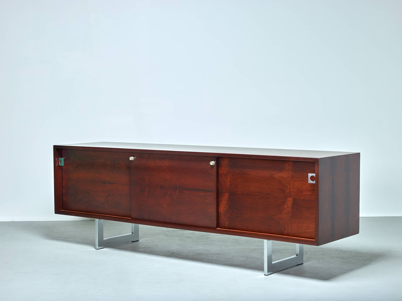 Bodil Kjaer cabinet.

E. Pedersen & Son,
Denmark, circa 1960.

Rosewood and stainless steel.
Measures: 72.25 W x 17 D x 25 H inches.

Original condition with backside outfitted for electrical. Can be re-finished.