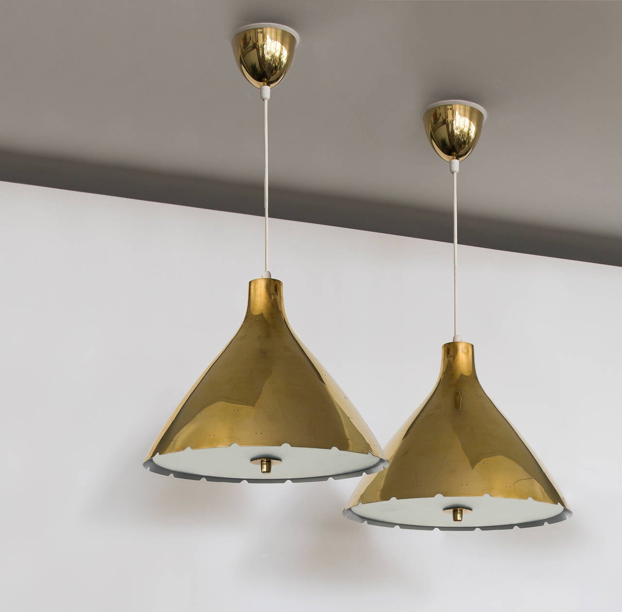 Paavo Tynell.

Brass ceiling lamps.

Taito Oy,
Finland, late 1940s-early 1950s.
Measures: Diameter 35 cm, height/drop 70 cm, height/shade 26 cm.

Impressed with makers mark TAITO.

Literature: Finland House catalog, pg 20 (model 10209 with