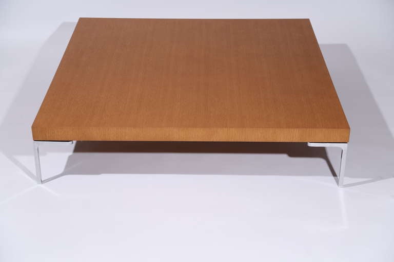 A low table with a square shape features the classic inverted L shaped foot that distinguishes the entire Charles collection by Antonio Citterio.  In Light Oak
