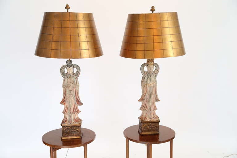 Pair of Asian figural lamps with original gold painted shades in the style of James Mont,

USA, circa 1950s.


Ceramic and brass.