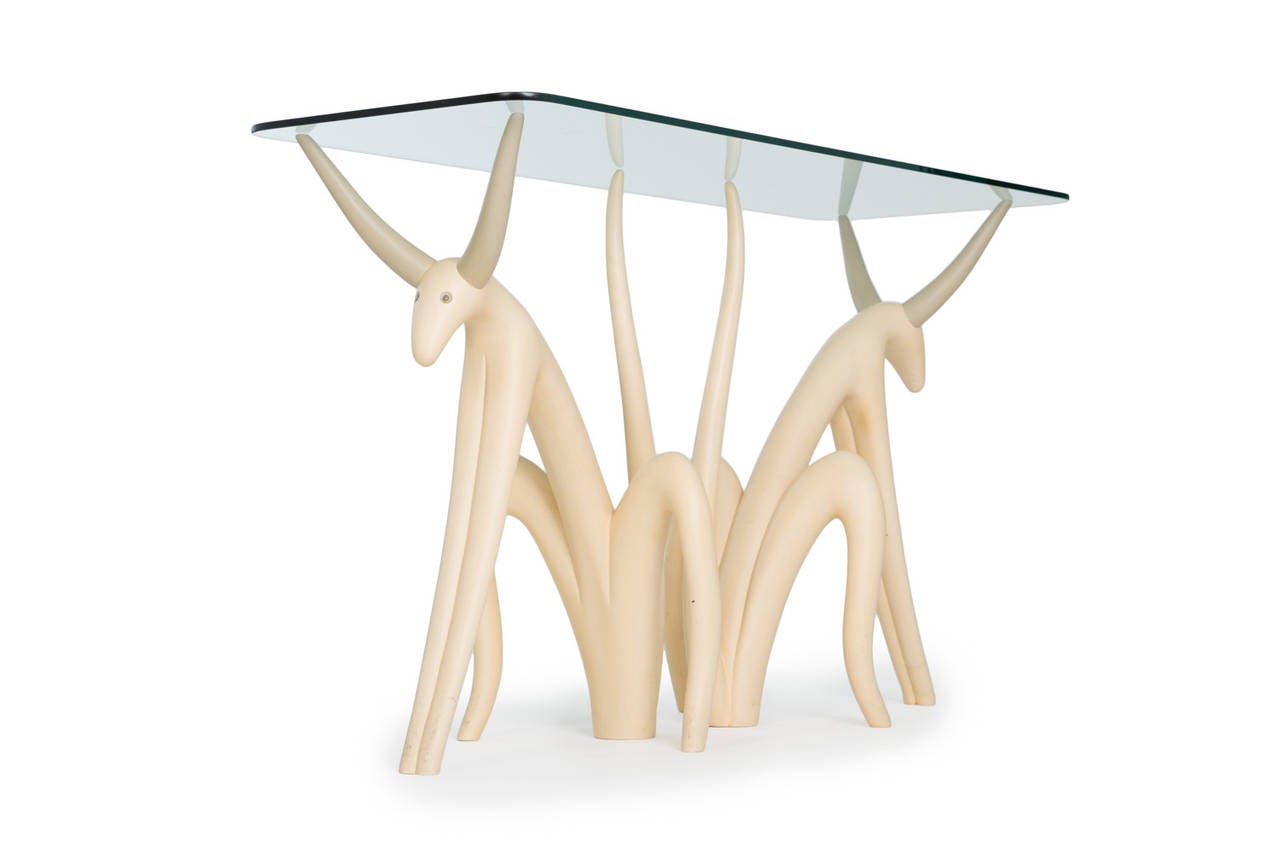 Judy Kensley McKie.

Pete and repeat table.

USA, circa 1981.
Carved and painted poplar, glass.
height 30 in (83.7 cm); length 52 in (132 cm); depth 18 in (45.7 cm).

Pete and repeat table.
Each figure inscribed with artist signature,