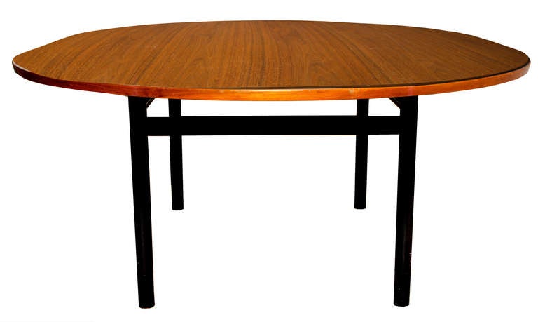 Edward Wormley dining table
 
Dunbar, USA, 1950.
Walnut, lacquered mahogany, leather cuffed. 

Signed with applied green rectangular manufacturer’s label to underside: [Dunbar Berne, Indiana].

Measures: Table has 20 inch leaf to extend to 80