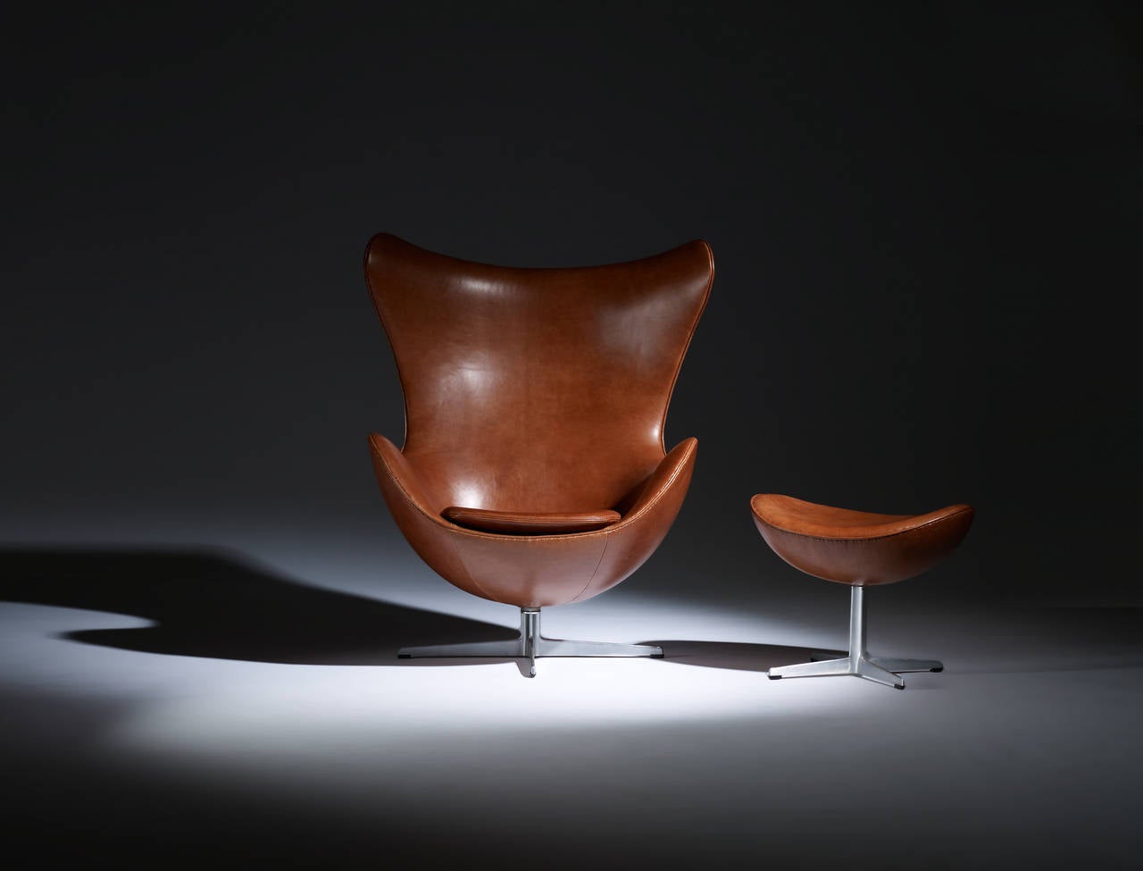 Arne Jacobsen.

Chair and ottoman.

Fritz Hansen,
Denmark, 1958.
Leather, cast aluminum, plastic.
Measures: 34 W x 32 D x 42 H inches.

Pair available (Two chairs and two ottomans)