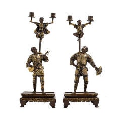 Antique A very fine pair of Japanese multi-patinated bronze candelabra.