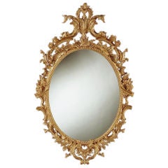 Antique A fine George II carved giltwood oval mirror.