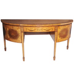 A  George III satinwood, mahogany and marquetry demi-lune sideboard.