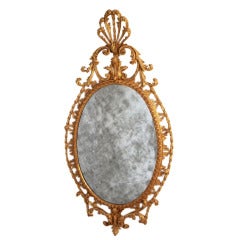 Antique A George III carved giltwood oval mirror.