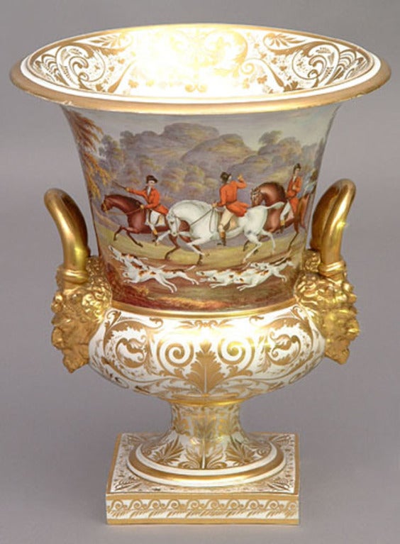 Rare and fine Duesbury and Kean period Derby campagna form porcelain urn with Etruscan masks in high relief above a flared foot and square pedestal base, with gilt rims, foot, ankle, handles and masks, the flared vase extremely well painted by