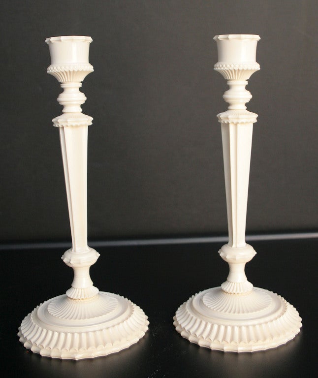 A fine pair of Anglo-Indian turned and elaborately carved ivory candlesticks with tapering fluted standards..