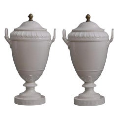 A pair of Berlin KPM ivory-glazed neoclassical porcelain urns