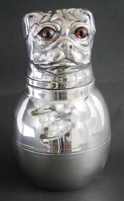 A 19th century silver-plated box with a hinged lid modeled as the head of a pug with glass eyes.