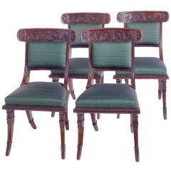 Antique A set of four Regency carved rosewood side chairs.