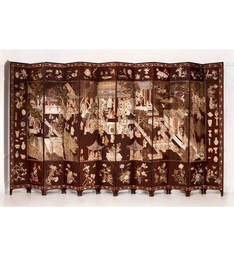 A Chinese brown-ground polychrome lacquer twelve-panel coromandel screen, depicting General Guo Ziyi, seated in the reception hall of his manor, being entertained and receiving guests bearing tribute, surrounded by women and children at play,