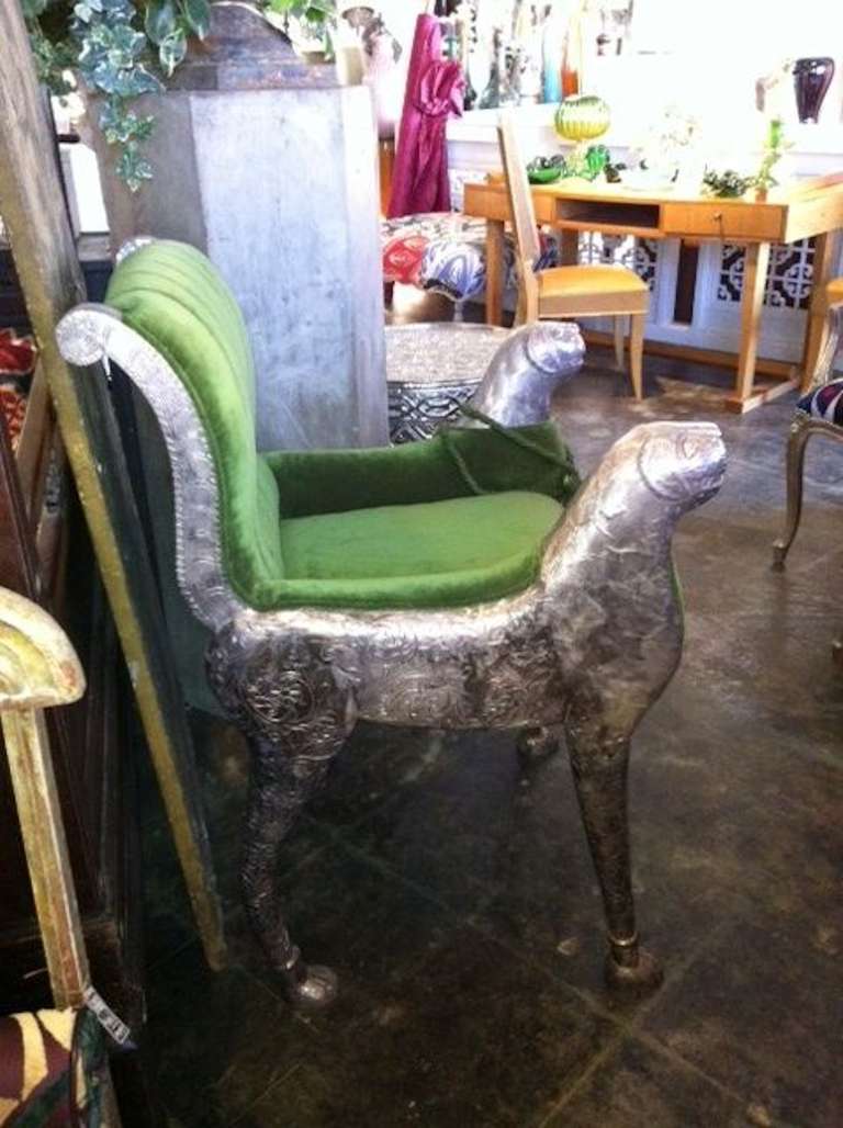 Beautiful silver-plated Raj Chair, upholstered in a moss green velvet fabric with repousse detailing. Arms are capped with details of animal heads and legs have paw feet.