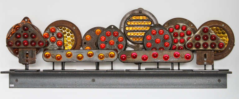 Collection of thirteen glass marble reflectors which would have been used on trucks or train crossings.  Heavy gauge metal inset with glass marbles.  Marbles have no chips and are unblemished.  Reflectors can be rearranged endlessly to make varied