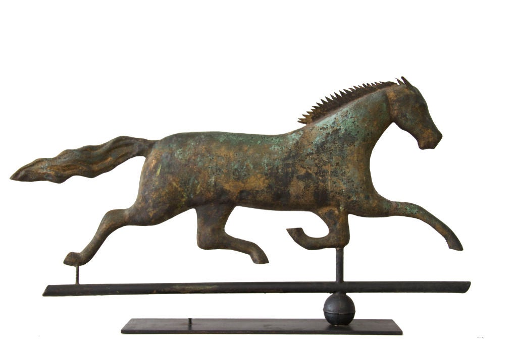 This spirited running horse weathervane is most unusual for its untouched, weathered surface showing vestiges of original mustard sizing and gold along with verdigris and oxidation consistent with age.  It is particularly rare in form because of the