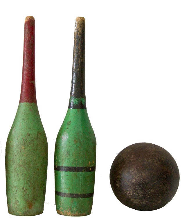Seven early, much used skittle pins shaped like early wine bottles.  Painted in hues of green, red, black and blue.  Very decorative.