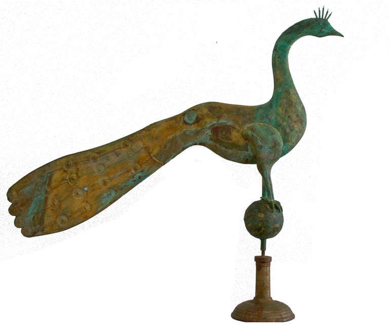 Early peacock weathervane attributed to A.L. Jewell and Company, Waltham, Massachusetts.  The extremely weathered surface of this piece is a pastiche of glorious color.  The body is composed of fluid, graceful shapes.  A stunning and decorative