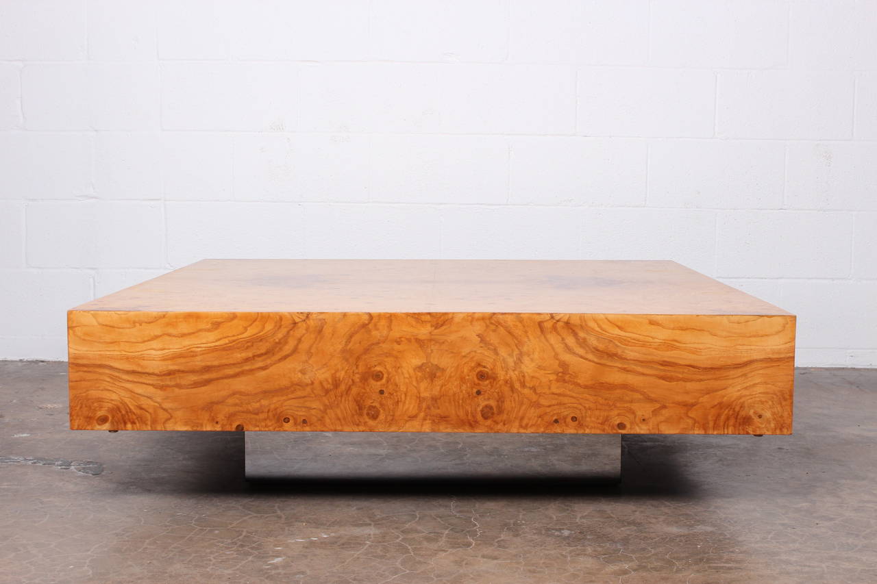 A large burl wood table on chrome base. Designed by Milo Baughman for Thayer Coggin.